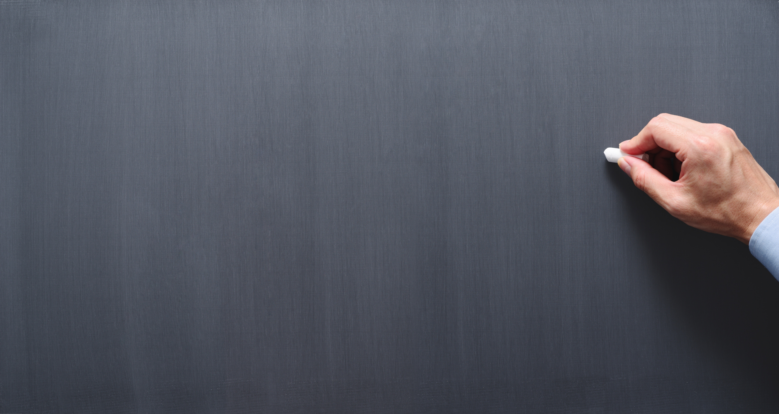 Teacher drawing on chalkboard.
