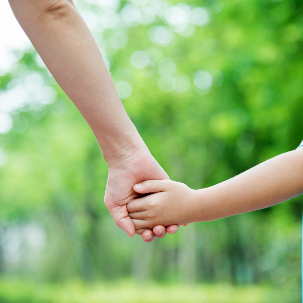 Mother and son holding hands